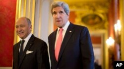 U.S. Secretary of State John Kerry, right, walks to a meeting with France's Foreign Minister Laurent Fabius at the Quai d' Orsay in Paris, Mar. 27, 2013.