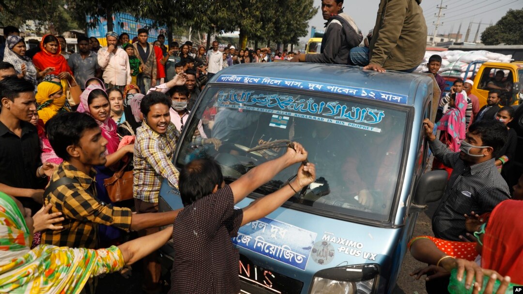 Bangladeshi garment workers vandalize a vehicle during a protest in Savar, on the outskirts of Dhaka, Bangladesh, Jan. 9, 2019. 