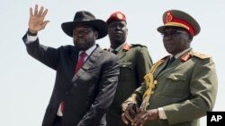 FILE - South Sudan's President Salva Kiir, left, accompanied by army chief of staff Paul Malong, right, waves during an independence day ceremony in the capital Juba, July 9, 2015.