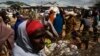 Somali refugees organize their collected ration of food during a distribution exercise outside a United Nations World Food Program center in Dagahale, one of the several refugee settlements in Dadaab, northeastern Kenya, October 8, 2013.