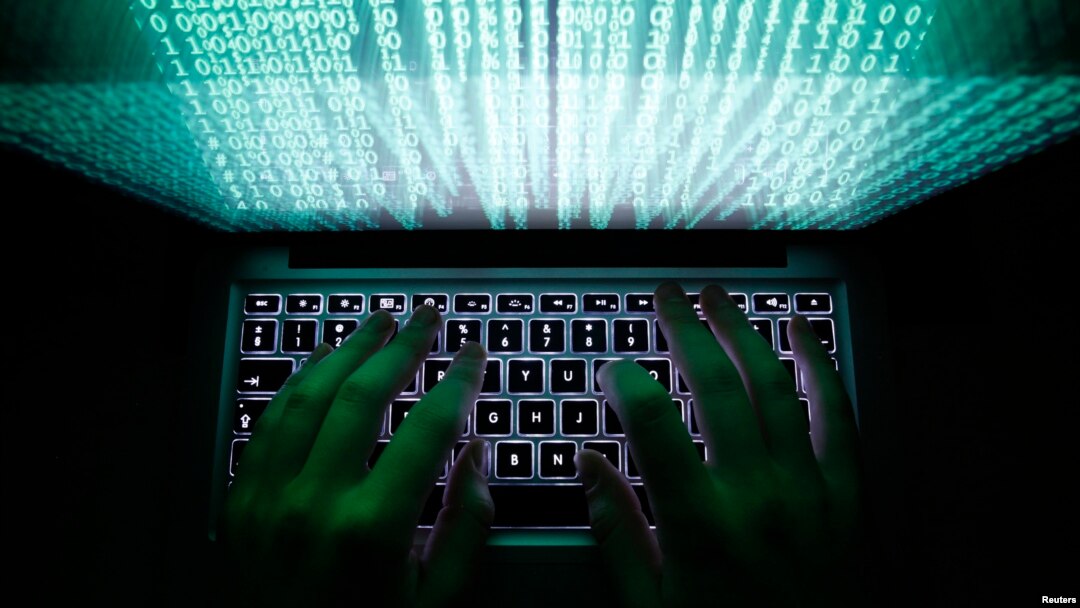 FILE - A man types on a computer keyboard.
