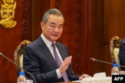 China's Foreign Minister Wang Yi gestures during a meeting with Cambodia's Foreign Minister Prak Sokhonn at the Cambodian Ministry of Foreign Affairs and International Cooperation in Phnom Penh on August 13, 2023. (Photo by AFP)