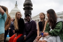 Swedish youth climate activist Greta Thunber, 16, sits on the side among other youth climate activists at a news conference about the Green New Deal hosted by U.S. Senator Ed Markey (D-MA) in front of the U.S. Capitol in Washington, Sept. 17, 2019.