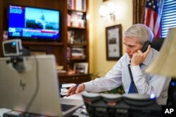 Sen. Rob Portman, R-Ohio, the top Republican negotiator on the bipartisan infrastructure bill, works from his office on Capitol Hill, Aug. 9, 2021.