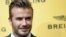 FILE - English former footballer David Beckham poses for photographers.