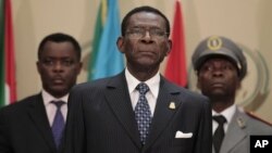 Equatorial Guinea President Teodoro Obiang (C) stands for the playing of the African Union anthem at the closing session of the 17th African Union Summit, at Sipopo Conference Center, outside Malabo, Equatorial Guinea, July 1, 2011.