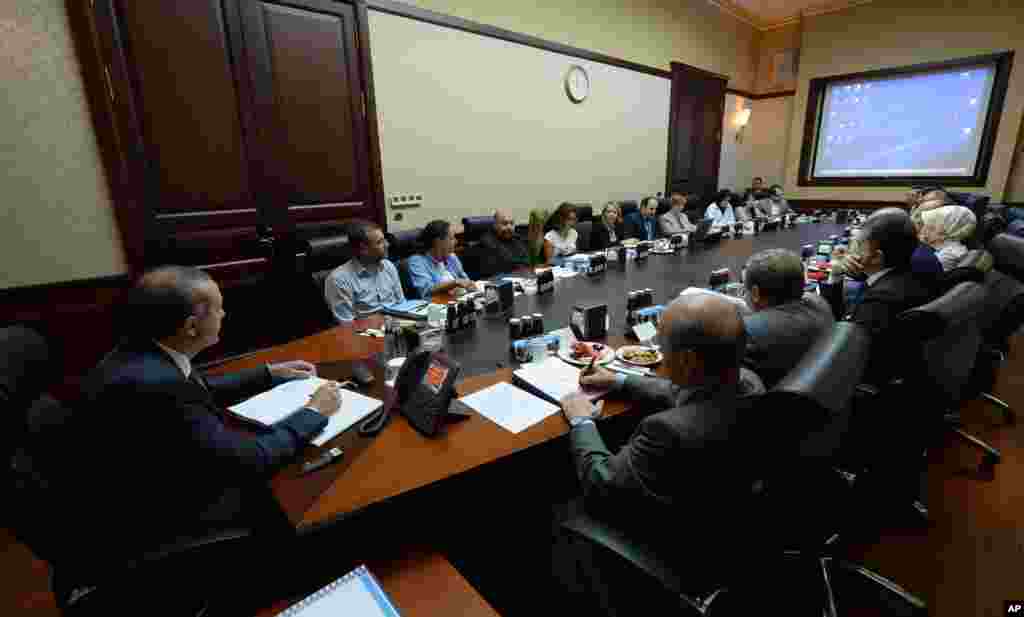 Turkish Prime Minister Recep Tayyip Erdogan, left, and some of his ministers and advisors meet with with a group of activists in his offices in Ankara, June 12, 2013.