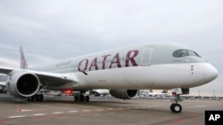 FILE - A Qatar Airways Airbus A350 approaches the gate at the airport in Frankfurt, Germany, Jan. 15, 2015.