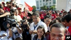 Thai anti-government Red Shirt leader Jutaporn Prompan, right, smiles as he talks with supporters and the media, Jan. 9, 2011, Bangkok, Thailand.