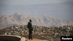 Jewish settler Refael Morris stands at an observation point overlooking the West Bank village of Duma, near Yishuv Hadaat, an unauthorized Jewish settler outpost January 5, 2016.