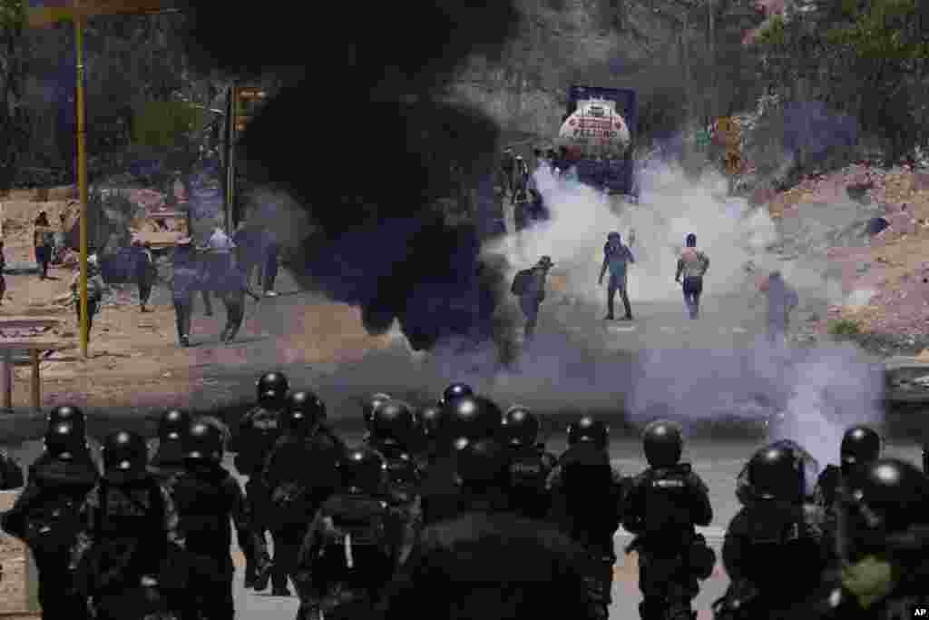 Police launch tear gas to disperse supporters of former President Evo Morales who have been blocking roads for days to prevent him from facing a criminal investigation over allegations of abuse of a minor while in office, in Parotani, Bolivia.