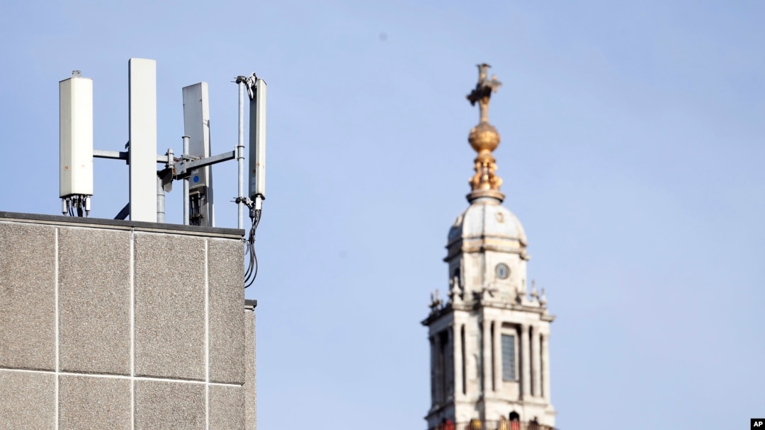 FILE - In this Tuesday, Jan 28, 2020 file photo, mobile network phone masts are visible in front of St Paul's Cathedral in the City of London. Dozens of European cell towers have been destroyed in recent arson attacks that officials and wireless…