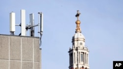 FILE - In this Tuesday, Jan 28, 2020 file photo, mobile network phone masts are visible in front of St Paul's Cathedral in the City of London. 
