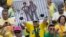 A demonstrator holds a poster with the photo of Brazilian president Dilma Rousseff and former President Luiz Inacio Lula da Silva in prison stripes during a protest on Copacabana beach in Rio de Janeiro, Brazil, March 13, 2016.