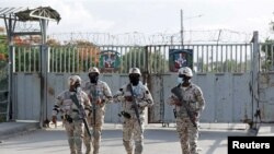 Members of the Dominican Republic's National Army guard the bridge between the Dominican Republic and Haiti, in Dajabon, Dominican Republic July 7, 2021. 