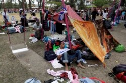 FILE - Central American migrants take a break from traveling toward the U.S., in Matias Romero, Oaxaca, Mexico, April 3, 2018.