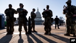 Members of the Michigan National Guard and the US Capitol Police keep watch as heightened security remains in effect around the Capitol grounds since the Jan. 6 attacks by a mob of supporters of then-President Donald Trump, in Washington, March 3, 2021.