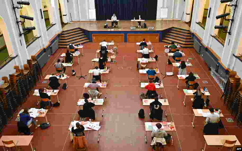 Students take the Biology Abitur (high school graduation) examination in the assembly hall of the Paul-Natorp-Gymnasium secondary school in Berlin, Germany.