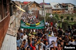 FILE - Kashmiri men shout slogans during a protest after the scrapping of the special constitutional status for Kashmir by the Indian government, in Srinagar, Aug. 11, 2019.