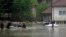 A rescue team makes its way in boats after flooding in in the Bosnian town of Maglaj, May 16, 2014. 