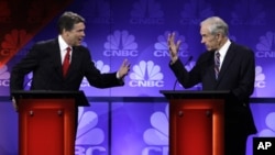 Republican presidential candidates Texas Gov. Rick Perry and Rep. Ron Paul, R-Texas, speak during a Republican Presidential Debate at Oakland University in Auburn Hills, Mich., Nov. 9, 2011.