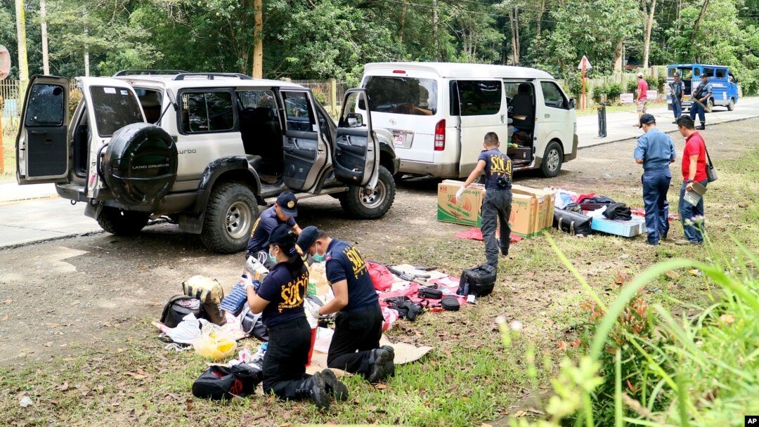 Police inspect the contents of the vehicles following an operation in Makilala township, North Cotabato province, in the southern Philippines, Oct. 28, 2016 