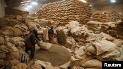 Employees process coffee at the Central Kenya Coffee Mill near Nyeri, Kenya, March 15, 2018. 