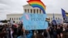 FILE - LGBTQ activists and supporters hold a rally outside the U.S. Supreme Court as it hears arguments in a major LGBTQ rights case in Washington, Oct. 8, 2019.