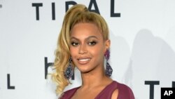 FILE -Beyonce arrives at TIDAL X: 1020 Amplified by HTC at the Barclays Center in New York. Beyonce released "Formation" on Saturday, Feb. 6, 2016 as a download on the streaming service, Tidal, which she co-owns with husband Jay Z, Rihanna and other artists. Taken Oct. 20, 2015.