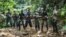 This picture taken on September 21, 2021 shows wildlife rangers posing with a sedated 9-meter long python, estimated to weigh about 100 kilograms, they caught near a village in Kampar and later released back into the neighbouring jungle of Palalawan. 