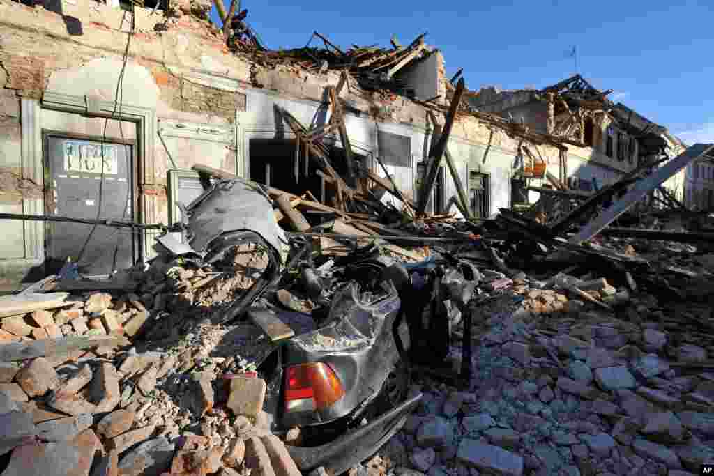 A view of a damaged car and buildings are seen after an earthquake in Petrinja, Croatia. The European Mediterranean Seismological Center says the magnitude 6.3 earthquake hit southeast of Zagreb, killing at least six people and injuring dozens.
