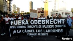 People take part in a march against the Brazilian construction firm Odebrecht in Panama City, Panama, Jan. 25, 2017. The banner reads "Get Out Odebrecht, Jail for the thieves." 