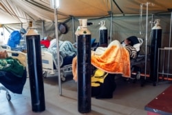 FILE - COVID-19 patients are being treated with oxygen at a hospital in Pretoria, South Africa, July 10, 2020.