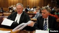 Oscar Pistorius's lawyers Barry Roux (L) and Brian Webber prepare documents before the start of the application to appeal some of his bail conditions at a Pretoria court in Pretoria, March 28, 2013. 