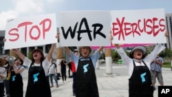 Protesters shout slogans to oppose planned joint military exercise between South Korea and the United States near the U.S. embassy in Seoul, South Korea, Aug. 5, 2019.