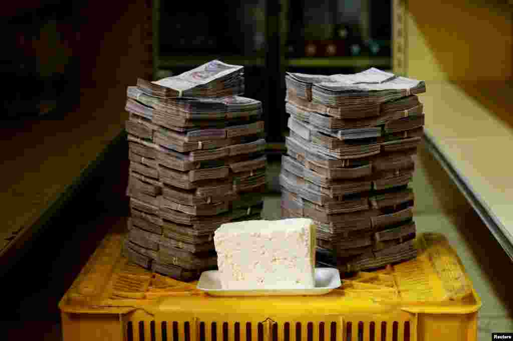 A kilogram of cheese is pictured next to 7,500,000 bolivars, the equivalent of $1.14.