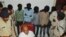 Five men, faces covered, are among the six accused of raping a Swiss tourist in central India, at police control room in Datia, March 17, 2013.
