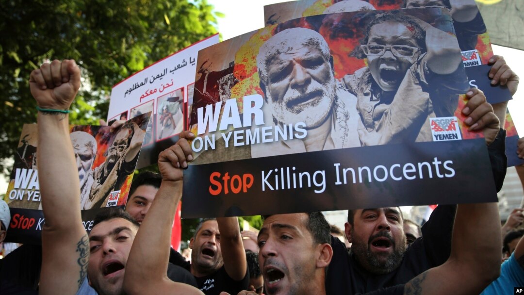 Lebanese supporters of the Iranian-backed Hezbollah group, hold placards and shout slogans against Saudi Arabia and the U.S., during a protest to show their solidarity with Yemen's Shiite rebels, known as Houthis, in front the United Nations headquarters,