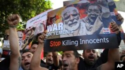 Lebanese supporters of the Iranian-backed Hezbollah group, hold placards and shout slogans against Saudi Arabia and the U.S., during a protest to show their solidarity with Yemen's Shiite rebels, known as Houthis, in front the United Nations headquarters,