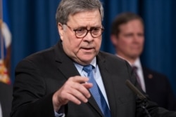 Attorney General William Barr speaks to reporters at the Justice Department in Washington, Jan. 13, 2020.