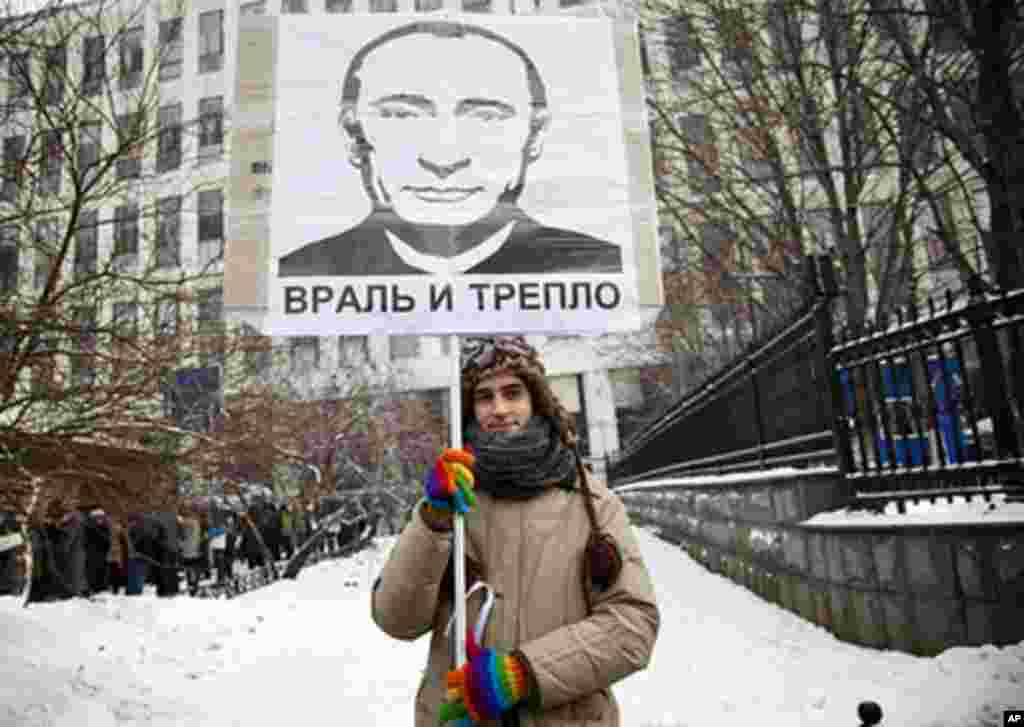 A young lawyer holds a sign that reads, "Liar and hypocrite." February 4, 2012. (VOA - Y. Weeks)