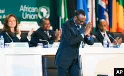 FILE - Rwanda's President Paul Kagame gestures after signing the African Continental Free Trade Area Agreement during the 10th Extraordinary Session of the African Union (AU) in Kigali, Rwanda, Wednesday, March 21, 2018.