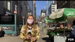 Celia Mendoza records a stand up on 34th street and 8th Ave after interviewing a street vendor about COVID and the economy. (Photo: Celia Mendoza / VOA)