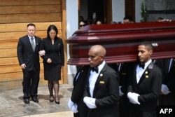 Funeral parlor employees carry the coffin of Peru's former president Alberto Fujimori in front of Fujimori's children Kenji and Keiko, in Lima, Sept. 12, 2024.