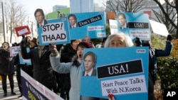 FILE - Protesters holding portraits of U.S. Deputy Secretary of State Tony Blinken denounce U.S. policy against North Korea at the Foreign Ministry in Seoul, South Korea, Feb. 9, 2015. 