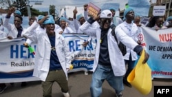 Kenyan doctors chant outside the health ministry headquarters protesting with placards to demand better pay and working conditions in the capital, Nairobi, on April 9, 2024.
