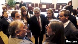 FILE - Chamber of Deputies President Osvaldo Andrade speaks with Socialist Senator Juan Pablo Letelier during a session in Chile's congress to process a controversial labor reform law in Valparaiso, Chile April 5, 2016.
