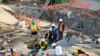 FILE— Emergency workers on the scene of a collapsed building in George, South Africa, May 7, 2024. Five workers have been killed with 49 still trapped after the building under construction collapsed Monday.