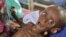 In this Tuesday, July 26, 2011 file photo, then seven month old Somali boy Minhaj Gedi Farah is treated in a field hospital of the International Rescue Committee (IRC) in Dadaab, Kenya. Somalia was hard hit by drought and parts of the country suffered fam