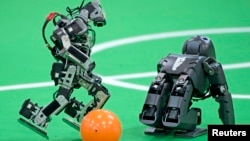 Robots play soccer in the Kids League at the RoboCup German Open 2014 in Magdeburg, Germany, April 3, 2014. (Reuters)